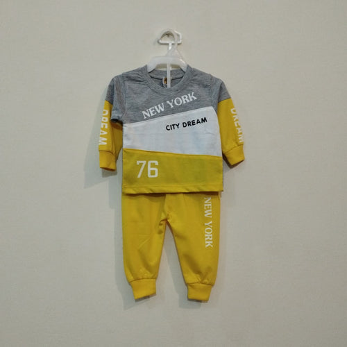 Children's yellow and gray outfit with 'New York' text on a hanger against a plain background